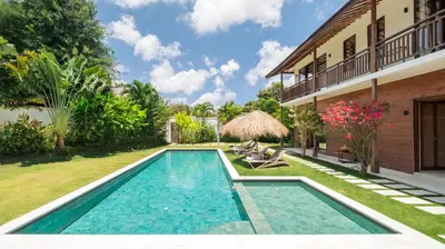 a swimming pool in the backyard of a house at Alea Estate by Villa Finder in Kerobokan