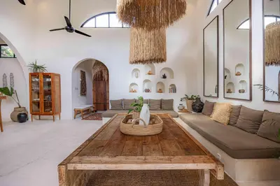 a living room with a couch and a table at Villa Mimpikita - Stunning Ibiza-Inspired Villa Near Umalas with Private Pool in Kerobokan
