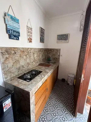 a kitchen with a stone counter and a sink at Casa Sophia by Kayana in Sanur