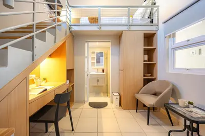 a room with a desk and a loft bed at Cove Nuansa Home in Jimbaran
