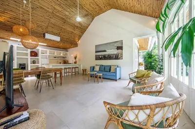 a living room and dining room with a table and chairs at The Oasis Villa in Kerobokan