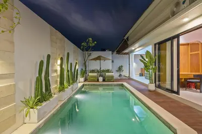 a swimming pool in a house with cactus at Rosso Verde 2BR Villa near Seminyak in Seminyak
