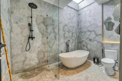 a bathroom with a shower with a tub and a toilet at Modern 4BR Industrial - Tropical Escape in Umalas in Kerobokan