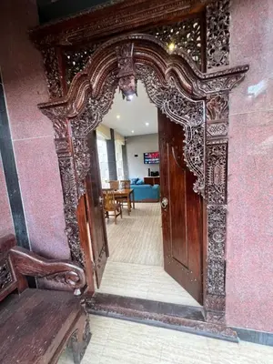 an ornate doorway to a room with a red wall at The Fatul Villa in Ngurah Rai International Airport