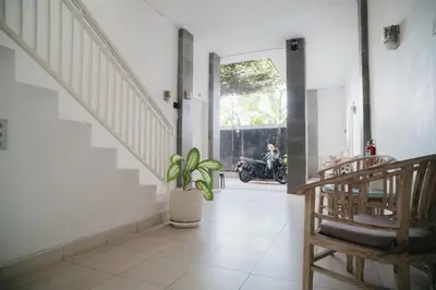 a room with a staircase and a motorcycle in the background at Adijaya Room 1 in Seminyak