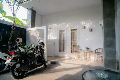a motorcycle parked in a room with a table at Adijaya Room 1 in Seminyak