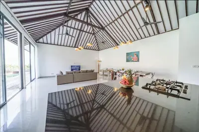 a large living room with white walls and a wooden ceiling at Villa Kusuma 2 Seminyak in Seminyak