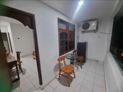 a kitchen with a table and chairs in a room at Mulia Legian guest house in Seminyak