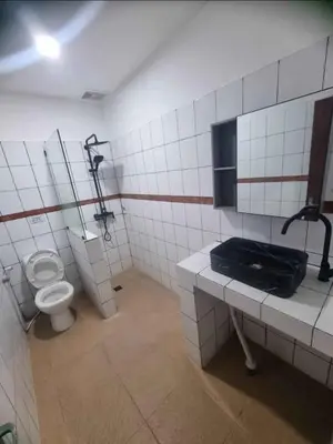 a bathroom with a toilet and a sink at Mulia Legian guest house in Seminyak
