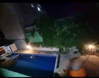 a view of a swimming pool at night at Mulia Legian guest house in Seminyak