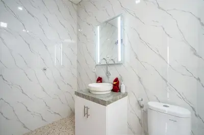 a white bathroom with a sink and a toilet at Luxury minimalist villa The Toy in Kerobokan