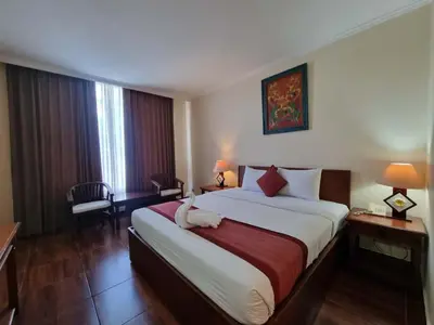 a bedroom with a large bed in a hotel room at Puri dibia apartment in Kuta