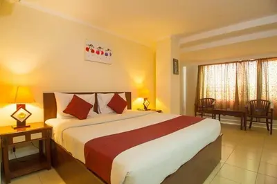 a bedroom with a large bed in a hotel room at Puri dibia apartment in Kuta