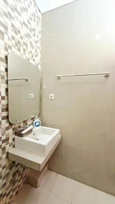 a bathroom with a sink and a mirror at Mahesa Seminyak in Seminyak