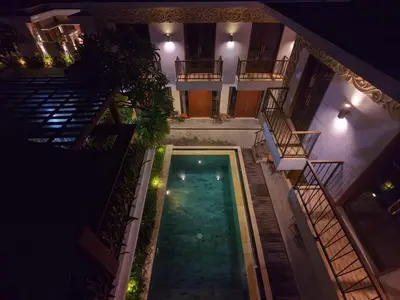 an overhead view of a pool in a building at night at Mahesa Seminyak in Seminyak