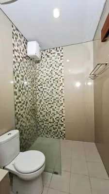 a bathroom with a toilet and a shower at Mahesa Seminyak in Seminyak