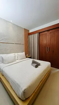 a bedroom with a large bed with white sheets at Mahesa Seminyak in Seminyak