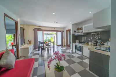a kitchen and living room with a table and chairs at Villa Sun Seminyak in Seminyak