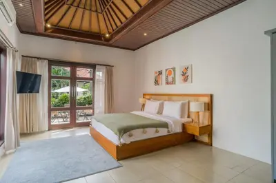 a bedroom with a bed and a large window at Villa Aura by Maheswara in Seminyak