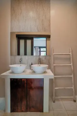a bathroom with two sinks and a mirror at Villa Aura by Maheswara in Seminyak