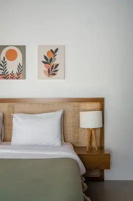 a bedroom with a bed and a table with a lamp at Villa Aura by Maheswara in Seminyak