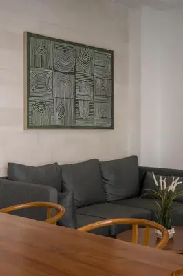 a living room with a couch and a picture on the wall at Villa Aura by Maheswara in Seminyak