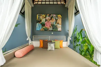 a window seat in a room with a painting on the wall at Luxury Aliya Villa by Betterplace in Sanur