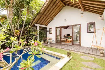 a villa with a swimming pool and a house at Lush 1 BR Private Pool Villa inSeminyak in Kerobokan