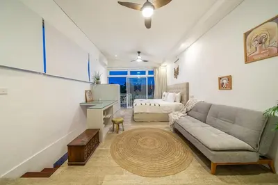 a living room with a couch and a table at Villa 888 Tropical Heart - 1BR Pool Villa Seminyak in Seminyak