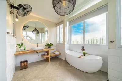 a bathroom with a tub and a sink and a mirror at Villa 888 Tropical Heart - 1BR Pool Villa Seminyak in Seminyak