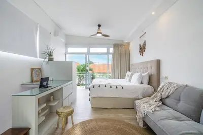 a bedroom with a bed and a desk and a couch at Villa 888 Tropical Heart - 1BR Pool Villa Seminyak in Seminyak