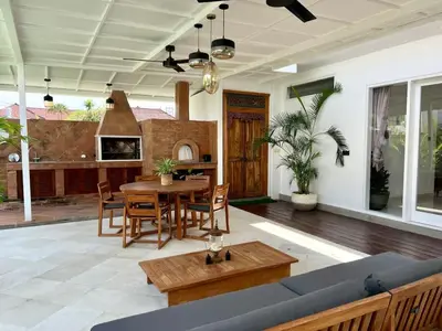 a living room with a blue couch and a table at 3BR Luxury Retreat Umalas with Pool - Villa Theo in Canggu