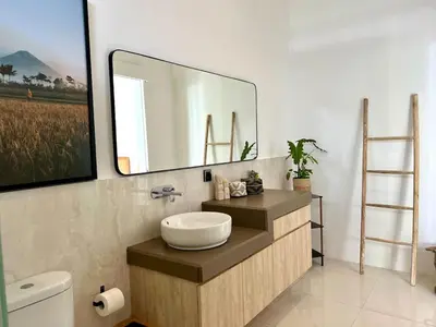 a bathroom with a sink and a large mirror at 3BR Luxury Retreat Umalas with Pool - Villa Theo in Canggu