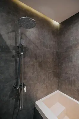 a bathroom with a shower with a tub at Casa Nika Suites Seminyak in Seminyak