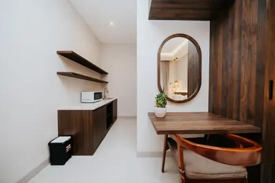 a bathroom with a wooden vanity and a mirror at Casa Nika Suites Seminyak in Seminyak