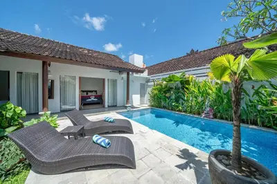 a backyard with a swimming pool and a villa at Villa Dream Seminyak in Seminyak
