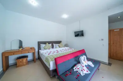 a bedroom with a bed and a desk and a bed sidx sidx sidx at Villa Dream Seminyak in Seminyak
