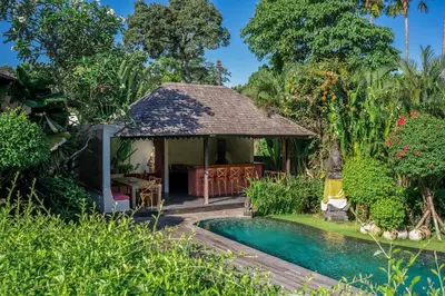 a house with a pool and a gazebo at Villa Yumi by BaliSuperHost in Canggu