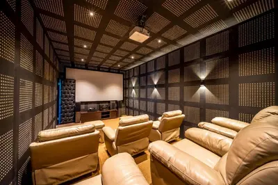 a screening room with leather chairs and a screen at Villa Yumi by BaliSuperHost in Canggu