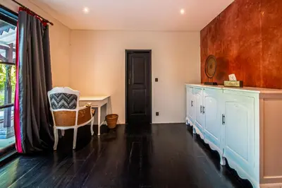 a room with a table and a chair and a door at Villa Yumi by BaliSuperHost in Canggu