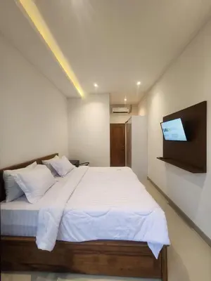 a bedroom with a bed with a tv on the wall at Bali Thousand Island in Pesanggaran
