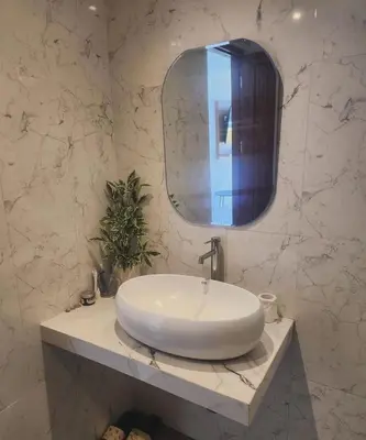 a bathroom with a white sink and a mirror at Bali Thousand Island in Pesanggaran