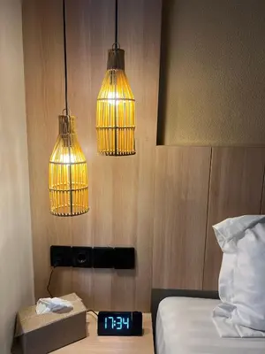 a room with three lights and a bed and a clock at Summerville Homes in Canggu