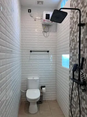 a bathroom with a toilet and a camera on the wall at Summerville Homes in Canggu