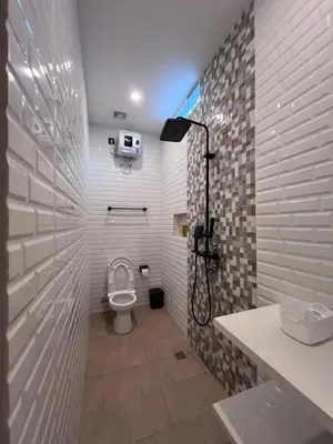 a bathroom with a toilet and a shower at Summerville Homes in Canggu
