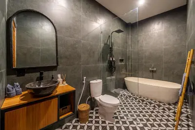 a bathroom with a tub and a toilet and a sink at Dasha 2- Chic 2BR in Canggu in Canggu