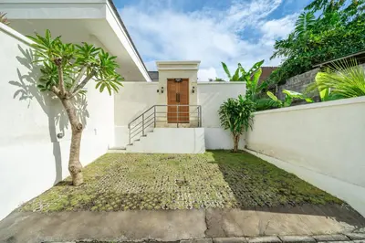 a house with a staircase leading to a door at Dasha 2- Chic 2BR in Canggu in Canggu