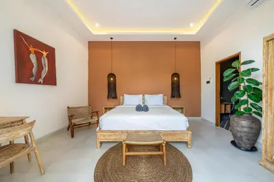 a bedroom with a bed and a table at Dasha 2- Chic 2BR in Canggu in Canggu