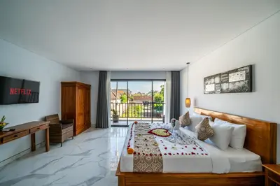 a hotel room with a bed and a desk at Villa Lotus Seminyak in Seminyak