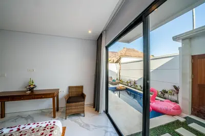 a room with a sliding glass door leading to a pool at Villa Lotus Seminyak in Seminyak